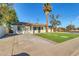 Front yard view of the renovated home with a palm tree at 7538 E Garfield St, Scottsdale, AZ 85257