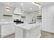 Modern white kitchen with marble countertops and gold fixtures at 7538 E Garfield St, Scottsdale, AZ 85257