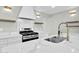 Modern kitchen with marble countertops and stainless steel appliances at 7538 E Garfield St, Scottsdale, AZ 85257