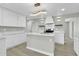 Modern kitchen featuring white cabinets, quartz countertops, and a large island at 7538 E Garfield St, Scottsdale, AZ 85257