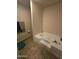 Bathroom with soaking tub and tile flooring at 821 W Kachina Trl, Phoenix, AZ 85040