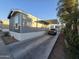 Gray manufactured home with carport and parking area at 821 W Kachina Trl, Phoenix, AZ 85040