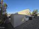 Side view of manufactured home with shed and desert landscaping at 821 W Kachina Trl, Phoenix, AZ 85040