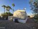 Rear view of gray manufactured home with shed and AC unit at 821 W Kachina Trl, Phoenix, AZ 85040