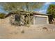 One story house with gray garage door and gravel landscaping at 9310 W Berkeley Rd, Phoenix, AZ 85037