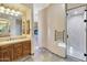 Elegant bathroom with double sinks, large mirror, and a walk-in shower at 10843 E La Junta Rd, Scottsdale, AZ 85255