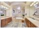 Spa-like bathroom with double sinks and a soaking tub at 10843 E La Junta Rd, Scottsdale, AZ 85255