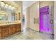 Spa-like bathroom featuring a walk-in shower with purple lighting at 10843 E La Junta Rd, Scottsdale, AZ 85255
