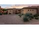 Stunning desert home with stone accents and a landscaped front yard at 10843 E La Junta Rd, Scottsdale, AZ 85255
