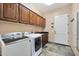 Laundry room with washer, dryer, and ample cabinet storage at 10843 E La Junta Rd, Scottsdale, AZ 85255