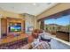 Spacious living room with stone fireplace and stunning mountain views at 10843 E La Junta Rd, Scottsdale, AZ 85255