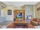 Living room with stone fireplace and built-in entertainment center at 10843 E La Junta Rd, Scottsdale, AZ 85255