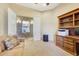 Spacious home office with built-in shelving and stone accent wall at 10843 E La Junta Rd, Scottsdale, AZ 85255
