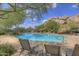 Relaxing community pool with lounge chairs and shade trees at 10843 E La Junta Rd, Scottsdale, AZ 85255