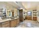 Elegant bathroom with vanity, large mirror, and wood cabinets at 11015 E Troon Mountain Dr, Scottsdale, AZ 85255