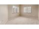 Simple bedroom with neutral walls, carpet, and two windows with blinds at 15050 N Thompson Peak Pkwy # 2006, Scottsdale, AZ 85260