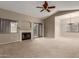 Spacious living room with a fireplace, sliding glass door, and ceiling fan at 15050 N Thompson Peak Pkwy # 2006, Scottsdale, AZ 85260