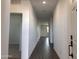 Bright and spacious hallway with wood-look tile flooring at 24131 W Sunland Ave, Buckeye, AZ 85326