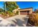 Home's exterior showcases a charming curb appeal with landscaping at 28831 N 128Th Dr, Peoria, AZ 85383