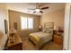 Cozy bedroom with ceiling fan and wood furniture at 333 E Redwood Ln, Phoenix, AZ 85048