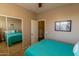 Bedroom with mirrored closet doors and a view of a second bedroom at 333 E Redwood Ln, Phoenix, AZ 85048