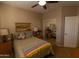 Spacious bedroom with mirrored closet doors and ceiling fan at 333 E Redwood Ln, Phoenix, AZ 85048