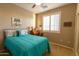 Charming bedroom with teal bedding and wooden desk at 333 E Redwood Ln, Phoenix, AZ 85048