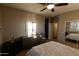Bedroom with dresser, ceiling fan and a view into another room at 333 E Redwood Ln, Phoenix, AZ 85048