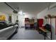 Attached garage with car, workbench, and storage at 333 E Redwood Ln, Phoenix, AZ 85048