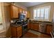 Kitchen features stainless steel appliances and wood cabinets at 333 E Redwood Ln, Phoenix, AZ 85048