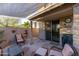 Stone patio with seating area, shade sail, and grill at 333 E Redwood Ln, Phoenix, AZ 85048