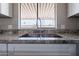 Double kitchen sink with granite countertop and modern faucet at 9302 E Broadway Rd # 073, Mesa, AZ 85208