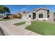 Single-story home with gray exterior,landscaped lawn, and a two-car garage at 10442 E Kiva Ave, Mesa, AZ 85209