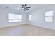 Bright and spacious bedroom with ceiling fan and wood-look tile floors at 1270 E Baranca Rd, Gilbert, AZ 85297