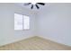 Simple bedroom with wood-look tile floors and ceiling fan at 1270 E Baranca Rd, Gilbert, AZ 85297