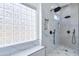 Spa-like shower with marble tile, rainfall shower head, and built-in shelving at 1270 E Baranca Rd, Gilbert, AZ 85297