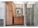 Bathroom features wood cabinets, granite countertop, and glass shower at 16616 E Palisades Blvd # 102, Fountain Hills, AZ 85268