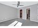 Spacious bedroom with carpet, ceiling fan and ensuite bathroom access at 16616 E Palisades Blvd # 102, Fountain Hills, AZ 85268
