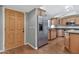 Entryway with wood door and flooring, leading to the kitchen at 16616 E Palisades Blvd # 102, Fountain Hills, AZ 85268