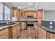 Kitchen with wood cabinets, granite counters, and stainless steel appliances at 16616 E Palisades Blvd # 102, Fountain Hills, AZ 85268