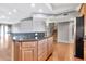 Large kitchen island with granite countertop and wood cabinets at 16616 E Palisades Blvd # 102, Fountain Hills, AZ 85268