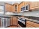 Stainless steel appliances and wood cabinets in this corner kitchen at 16616 E Palisades Blvd # 102, Fountain Hills, AZ 85268