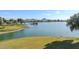 Scenic view of lake with lush landscaping and mountain backdrop at 16616 E Palisades Blvd # 102, Fountain Hills, AZ 85268