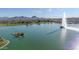Aerial view of a lake with a fountain and mountain backdrop at 16616 E Palisades Blvd # 102, Fountain Hills, AZ 85268