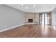 Living room features hardwood floors, stone fireplace, and access to patio at 16616 E Palisades Blvd # 102, Fountain Hills, AZ 85268