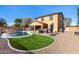 Large backyard oasis with a pool, spa, and outdoor kitchen at 17395 W Straight Arrow Ln, Surprise, AZ 85387