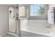 Bathroom with shower and bathtub, updated fixtures at 17395 W Straight Arrow Ln, Surprise, AZ 85387