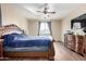 Bright bedroom featuring a king-size bed and large window at 17395 W Straight Arrow Ln, Surprise, AZ 85387