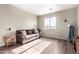 Relaxing bedroom with a brown sofa and large window at 17395 W Straight Arrow Ln, Surprise, AZ 85387