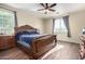 Primary bedroom with a large wooden bed frame and plenty of natural light at 17395 W Straight Arrow Ln, Surprise, AZ 85387